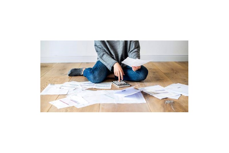 Woman on the floor surrounded by paperwork